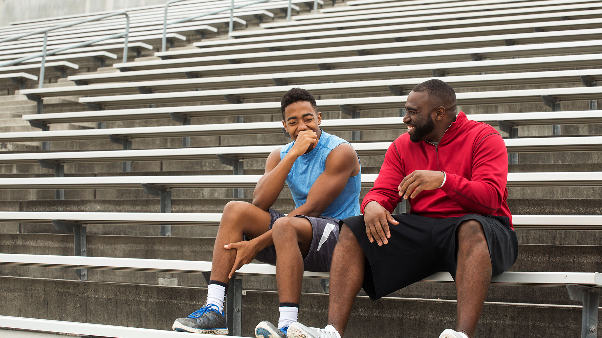 Coach and student laughing together.